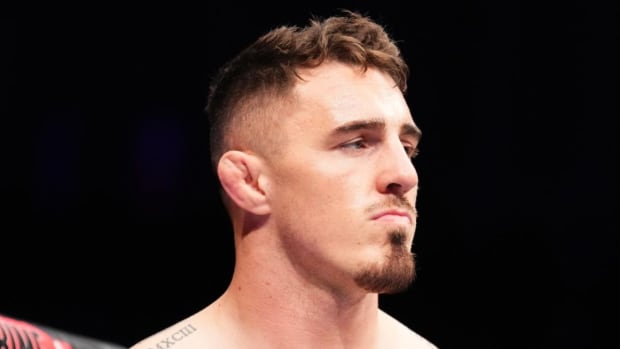 Tom Aspinall stares down his opponent inside the UFC Octagon.