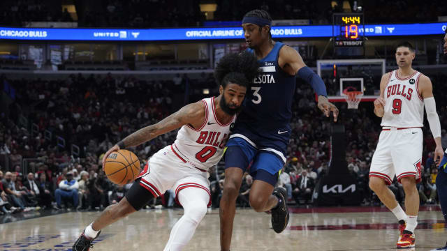 Minnesota Timberwolves forward Jaden McDaniels (3) defends Chicago Bulls guard Coby White (0) during the first quarter at United Center.