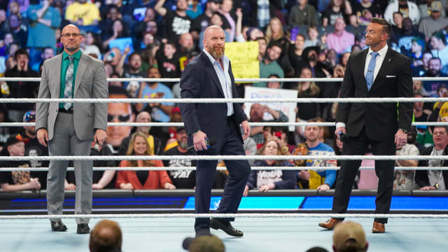 Paul "Triple H" Levesque, Adam Pearce, and Nick Aldis inside the ring for WWE SmackDown.