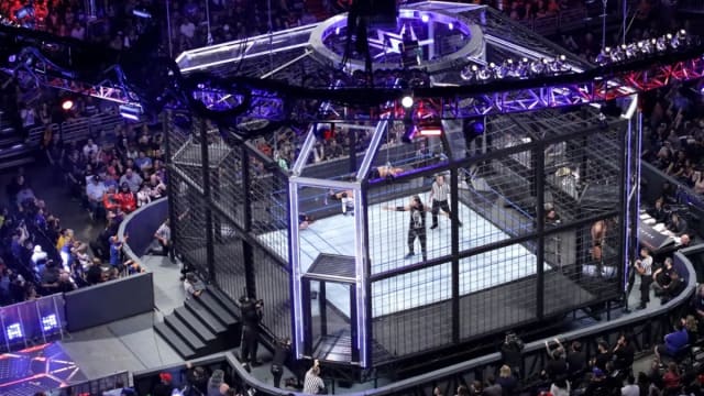 The WWE Elimination Chamber structure from a crowd view.