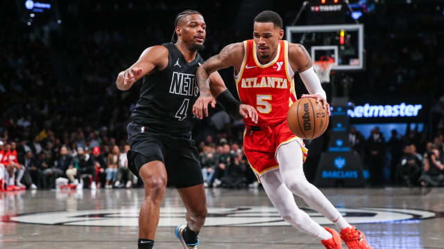 Feb 29, 2024; Brooklyn, New York, USA; Atlanta Hawks guard Dejounte Murray (5) moves past Brooklyn Nets guard Dennis Smith Jr. (4) in the fourth quarter at Barclays Center. Mandatory Credit: Wendell Cruz-USA TODAY Sports