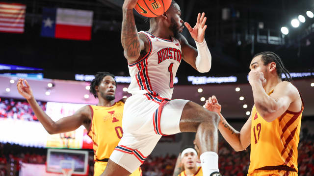 Houston guard Jamal Shead (1) looks to pass the ball during the second half against Iowa State at Fertitta Center in Houston on Feb. 19, 2024.