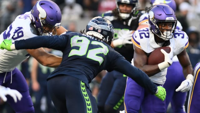 Seattle Seahawks outside linebacker Tyreke Smith (92) attempts to tackle Minnesota Vikings running back Ty Chandler (32) during the first half at Lumen Field.