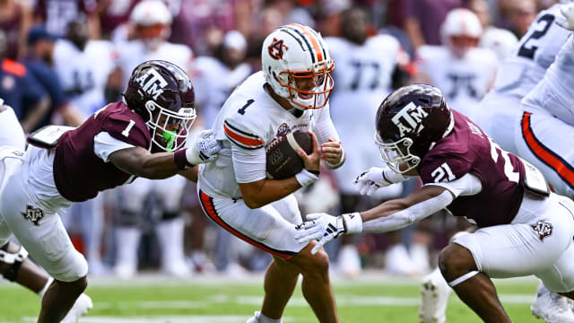 Auburn Tigers quarterback Payton Thorne (1) is tackled by Texas A&M Aggies defensive back Bryce Anderson (1) and linebacker Taurean York (21) during the first quarter at Kyle Field.