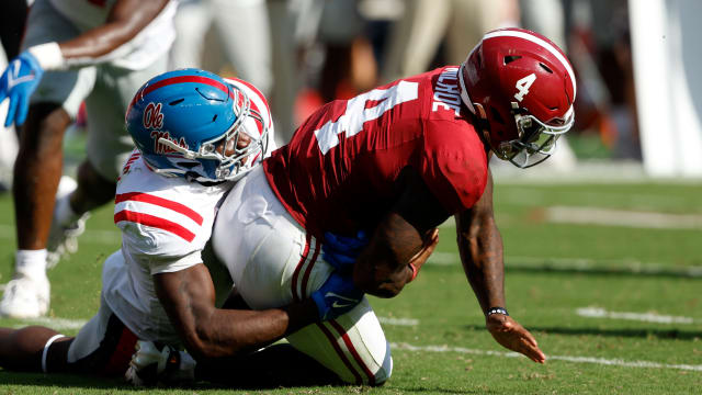 Sep 23, 2023; Tuscaloosa, Alabama, USA; Alabama Crimson Tide quarterback Jalen Milroe (4) is sacked by Mississippi Rebels linebacker Suntarine Perkins (4) during the first half at Bryant-Denny Stadium.