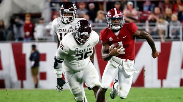 Alabama Crimson Tide quarterback Jalen Milroe (4) scrambles away from Texas A&M Aggies defensive lineman McKinnley Jackson (35) during the first half at Bryant-Denny Stadium.