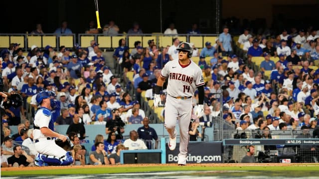 Arizona Diamondbacks catcher Gabriel Moreno (14) flips the bat after hitting a three-run home run off Clayton Kershaw in the first inning of Game 1 of the National League Division Series.