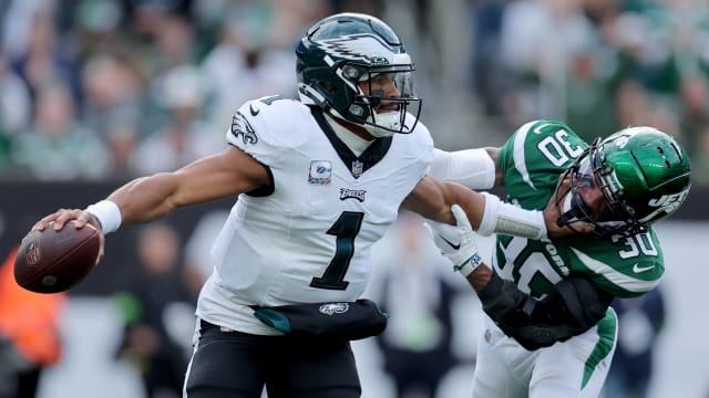 Jets' CB Michael Carter II tries to bring down Eagles' QB Jalen Hurts