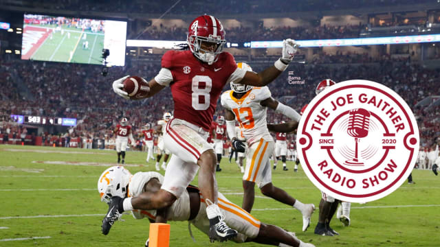 Oct 23, 2021; Tuscaloosa, Alabama, USA; Alabama Crimson Tide wide receiver John Metchie III (8) leaps over a Tennessee Volunteers defender to score a touchdown at Bryant-Denny Stadium. Alabama won 52-24. Mandatory Credit: Gary Cosby Jr.-USA TODAY Sports