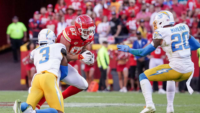 Oct 22, 2023; Kansas City, Missouri, USA; Kansas City Chiefs tight end Travis Kelce (87) runs the ball as Los Angeles Chargers safety Derwin James Jr. (3) makes the tackle during the first half at GEHA Field at Arrowhead Stadium. Mandatory Credit: Denny Medley-USA TODAY Sports  