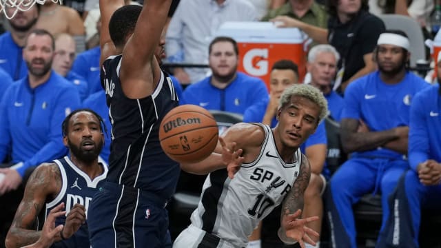 Oct 25, 2023; San Antonio, Texas, USA; San Antonio Spurs forward Jeremy Sochan (10) passes around Dallas Mavericks forward Grant Williams (3) in the second half at the Frost Bank Center.