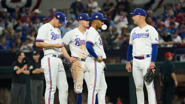 Oct 28, 2023; Arlington, TX, USA; Texas Rangers shortstop Corey Seager (5) third baseman Josh Jung (6) second baseman Marcus Semien (2) first baseman Nathaniel Lowe (30) wait during the pitcing change in the seventh inning against the Arizona Diamondbacks in game two of the 2023 World Series at Globe Life Field. Mandatory Credit: Raymond Carlin III-USA TODAY Sports