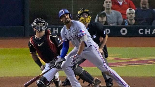 Texas Rangers second baseman Marcus Semien watches his three-run home run in the third inning against the Arizona Diamondbacks in Game 4 of the 2023 World Series Tuesday at Chase Field in Phoenix.