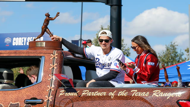 Texas Rangers shortstop Corey Seager holds onto the World Series MVP trophy during the World Series championship parade Friday afternoon at Globe Life Field.