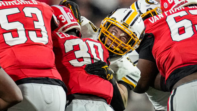 Missouri Tigers linebacker Chuck Hicks (30) tackles Georgia Bulldogs running back Daijun Edwards (30) during the second half at Sanford Stadium.