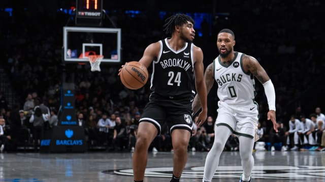 Brooklyn Nets guard Cam Thomas (24) looks for an opening against Milwaukee Bucks guard Damian Lillard (0)