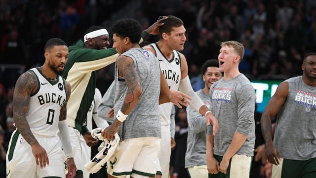 Milwaukee Bucks forward Bobby Portis (9) celebrates a three-point shot by Milwaukee Bucks center Brook Lopez (11) 