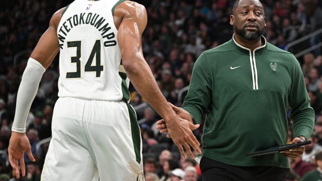  Milwaukee Bucks coach Adrian Griffin low fives Milwaukee Bucks forward Giannis Antetokounmpo (34) 