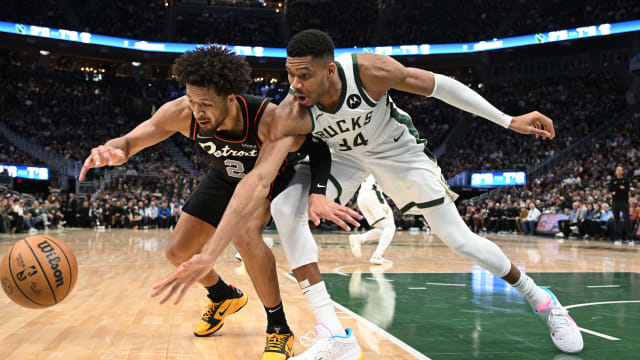 Detroit Pistons guard Cade Cunningham (2) and Milwaukee Bucks forward Giannis Antetokounmpo (34)