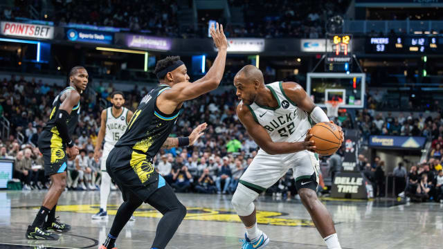 Milwaukee Bucks forward Khris Middleton (22) looks to dribble the ball while Indiana Pacers forward Bruce Brown (11) 