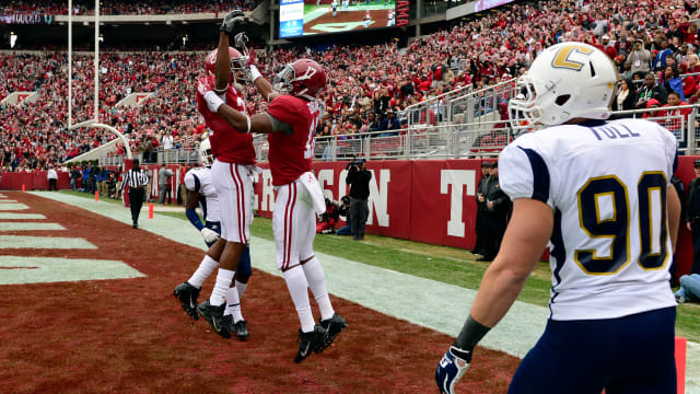 Alabama Crimson Tide running back Kenyan Drake (17) celebrates his touchdown in the end zone with wide receiver Christion Jones (22) past Chattanooga Mocs defensive lineman Davis Tull (90)