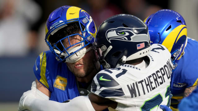 Seattle Seahawks cornerback Devon Witherspoon (21) sacks Los Angeles Rams quarterback Matthew Stafford (9) in the first quarter at SoFi Stadium.