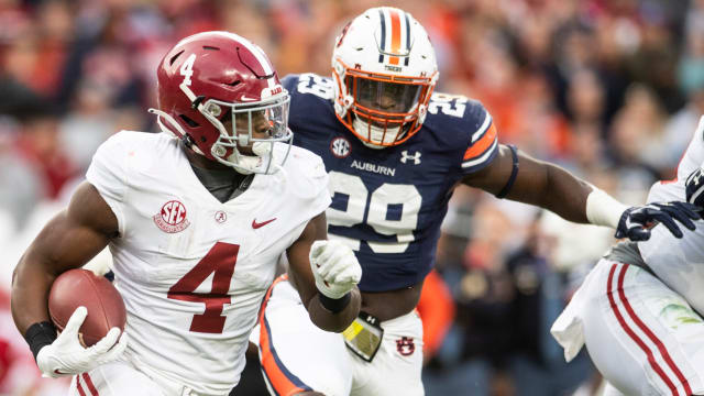 Alabama Crimson Tide running back Brian Robinson Jr. (4) runs the ball during the Iron Bowl at Jordan-Hare Stadium in Auburn, Ala., on Saturday, Nov. 27, 2021. Auburn Tigers leads Alabama Crimson Tide 7-0 at halftime.