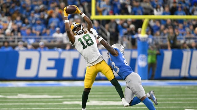 Green Bay Packers receiver Malik Heath catches a pass over Detroit Lions cornerback Jerry Jacobs.