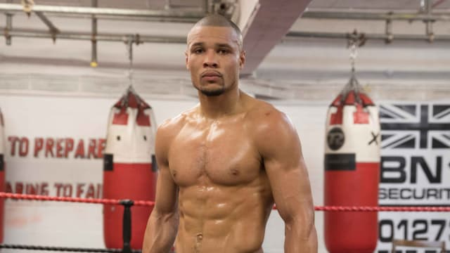 Chris Eubank Jr. poses for a picture while inside a boxing gym.