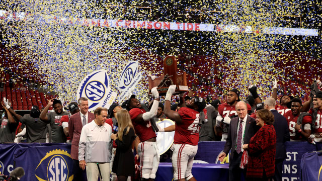 Dec 4, 2021; Atlanta, GA, USA; Alabama Crimson Tide inebacker Will Anderson Jr. (31), and defensive lineman Phidarian Mathis (48) lift the SEC championship trophy after their win against the Georgia Bulldogs at Mercedes-Benz Stadium.