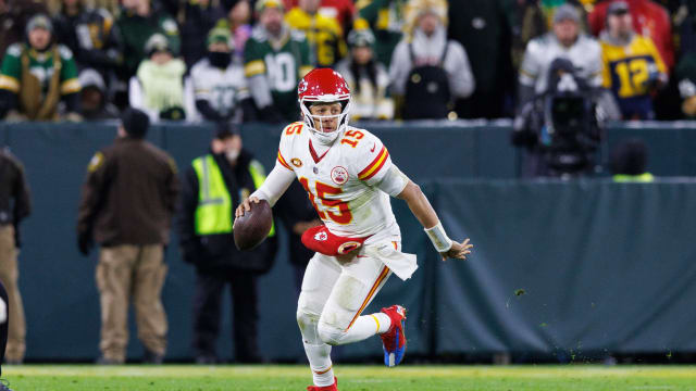 Dec 3, 2023; Green Bay, Wisconsin, USA; Kansas City Chiefs quarterback Patrick Mahomes (15) scrambles with the football during the fourth quarter against the Green Bay Packers at Lambeau Field. Mandatory Credit: Jeff Hanisch-USA TODAY Sports  