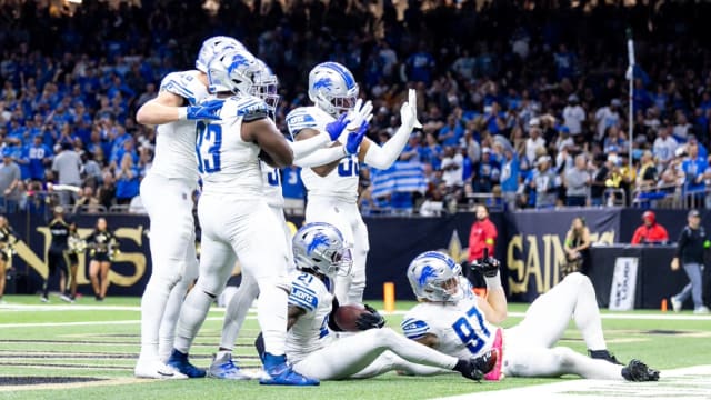 Detroit Lions defense celebrates a turnover against the New Orleans Saints.