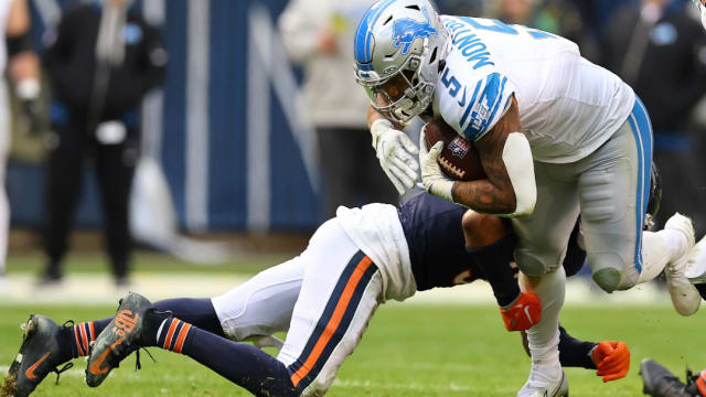 Detroit Lions running back David Montgomery is tackled by a Chicago Bears defender.