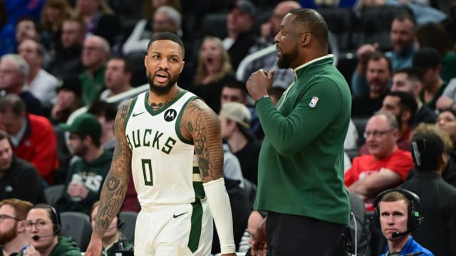 Milwaukee Bucks head coach Adrian Griffin talks to guard Damian Lillard (0) 