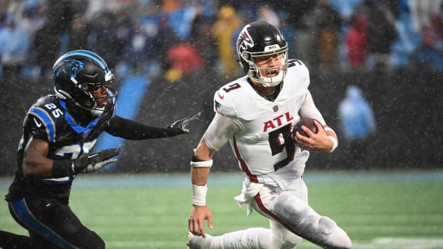 Dec 17, 2023; Charlotte, North Carolina, USA; Atlanta Falcons quarterback Desmond Ridder (9) runs as Carolina Panthers safety Xavier Woods (25) defends in the fourth quarter at Bank of America Stadium.