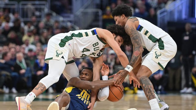 Indiana Pacers center Bennedict Mathurin (00) battles for a loose ball against Milwaukee Bucks guard Andre Jackson Jr. (44)  with MarJon Beauchamp