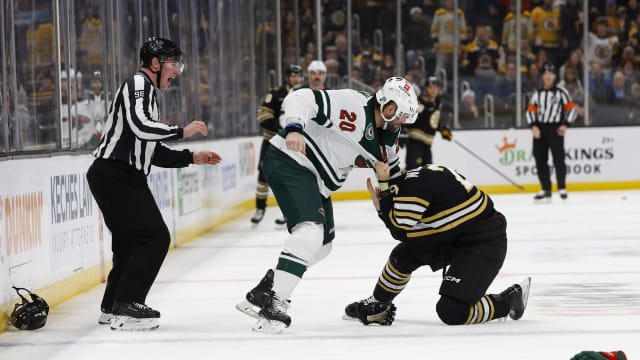 Dec 19, 2023; Boston, Massachusetts, USA; Minnesota Wild left wing Pat Maroon (20) takes down Boston Bruins defenseman Parker Wotherspoon (29) in a fight during the second period at TD Garden.