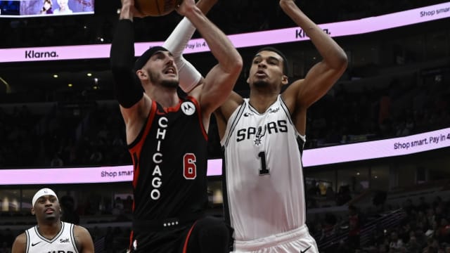 Chicago Bulls guard Alex Caruso (6) shoots against San Antonio Spurs center Victor Wembanyama (1) during the first half at the United Center.