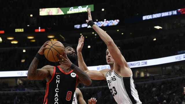 Chicago Bulls guard Coby White (0) shoots the ball against San Antonio Spurs forward Zach Collins (23) during the first half at the United Center.