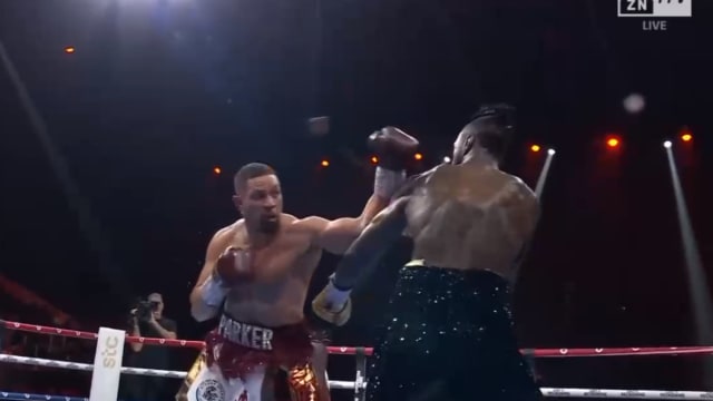 Joseph Parker throws a punch at Deontay Wilder during their boxing match.