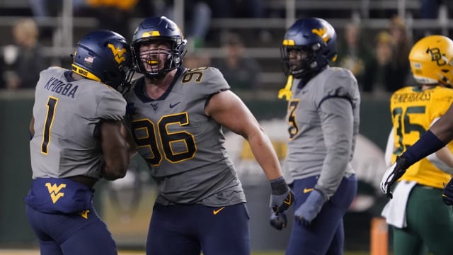 Nov 25, 2023; Waco, Texas, USA; West Virginia Mountaineers defensive lineman Edward Vesterinen (96) reacts with linebacker Lee Kpogba (1) after a sack against the Baylor Bears during the second half at McLane Stadium.