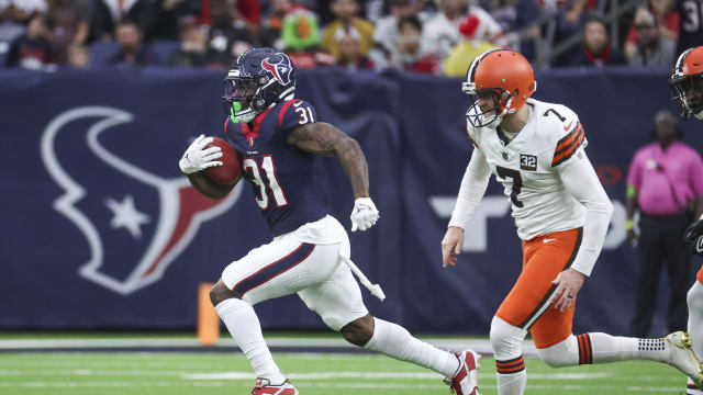 Dec 24, 2023; Houston, Texas, USA; Houston Texans running back Dameon Pierce (31) runs past Cleveland Browns place kicker Dustin Hopkins (7) to score a touchdown on a kickoff return during the second quarter at NRG Stadium. Mandatory Credit: Troy Taormina-USA TODAY Sports