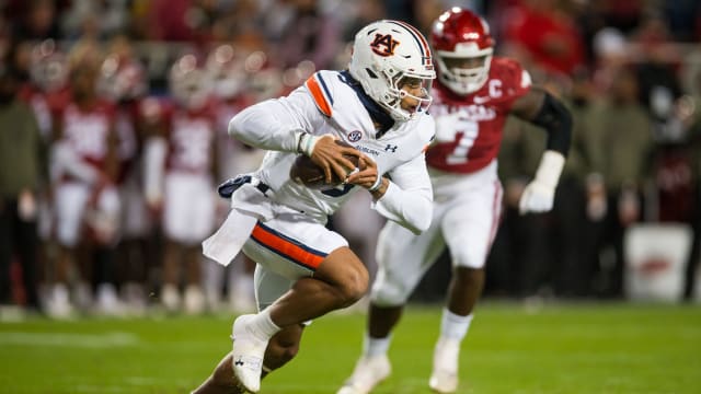 Nov 11, 2023; Fayetteville, Arkansas, USA; Auburn Tigers quarterback Robby Ashford (9) runs the ball during the fourth quarter against the Arkansas Razorbacks at Donald W. Reynolds Razorback Stadium. Auburn won 48-10. Mandatory Credit: Brett Rojo-USA TODAY Sports