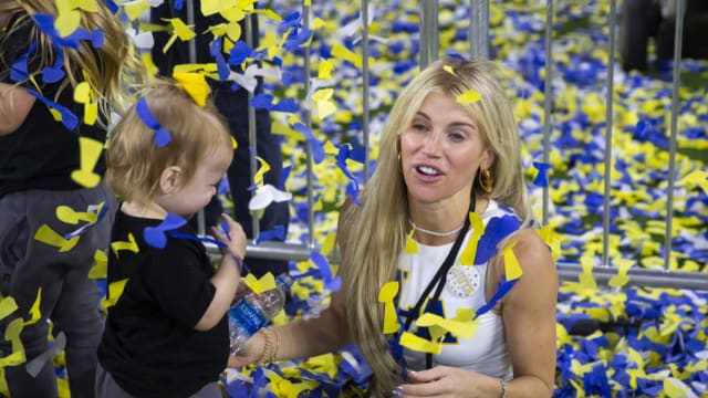 Kelly Stafford plays in confetti with her daughter after the Los Angeles Rams won the Super Bowl.