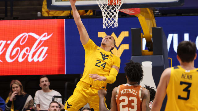 West Virginia forward Pat Suemnick delivers a reverse slam dunk vs. No. 25 Texas.