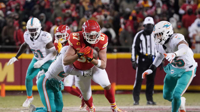 Jan 13, 2024; Kansas City, Missouri, USA; Kansas City Chiefs tight end Travis Kelce (87) runs the ball against the Miami Dolphins during the first half of the 2024 AFC wild card game at GEHA Field at Arrowhead Stadium. Mandatory Credit: Denny Medley-USA TODAY Sports  