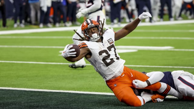 Jan 13, 2024; Houston, Texas, USA; Cleveland Browns running back Kareem Hunt (27) scores a touch down as he is tackled by Houston Texans defense in a 2024 AFC wild card game at NRG Stadium. Mandatory Credit: Thomas Shea-USA TODAY Sports