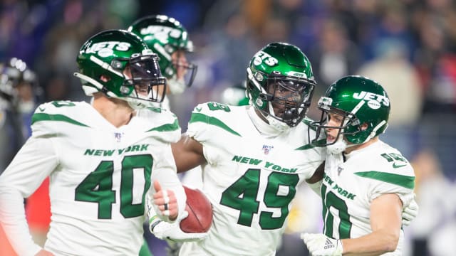 Dec 12, 2019; Baltimore, MD, USA; New York Jets linebacker B.J. Bello (49) celebrates with with teamamtes after returning a blocked punt for a touchdown against the Baltimore Ravens in the fourth quarter at M&T Bank Stadium. Mandatory Credit: Tommy Gilligan-USA TODAY Sports  