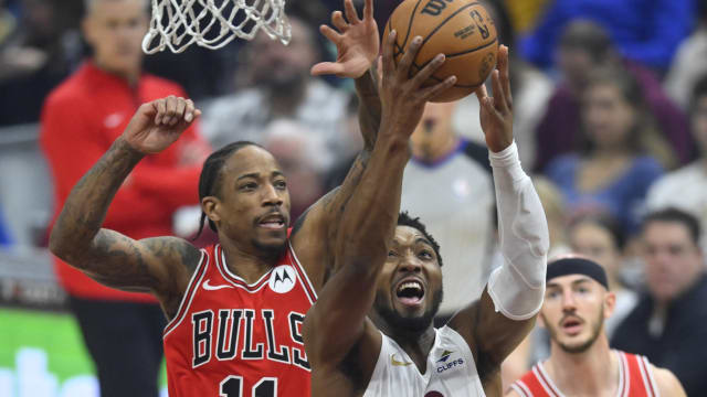  Chicago Bulls forward DeMar DeRozan (11) defends a shot by Cleveland Cavaliers guard Donovan Mitchell (45) in the first quarter at Rocket Mortgage FieldHouse. 