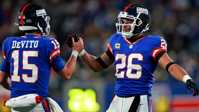 Tommy DeVito celebrates a touchdown with Saquon Barkley.